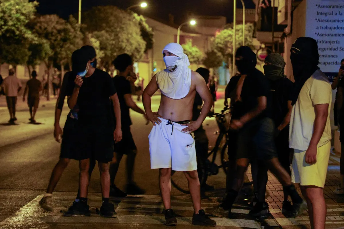 What's caused the recent anti-migrant unrest in Spain?