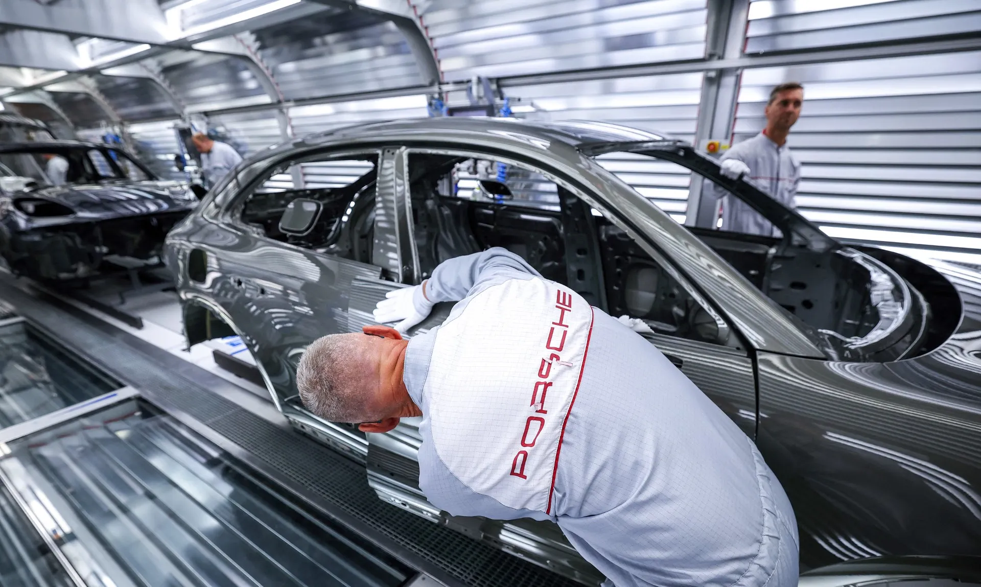 Porsche slows electric shift, prompting VW profit warning