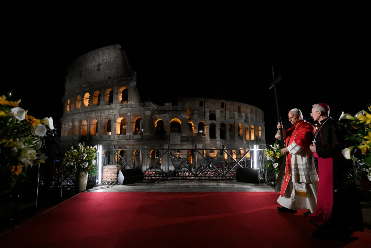 Pope leads torch-lit Colosseum procession before Easter