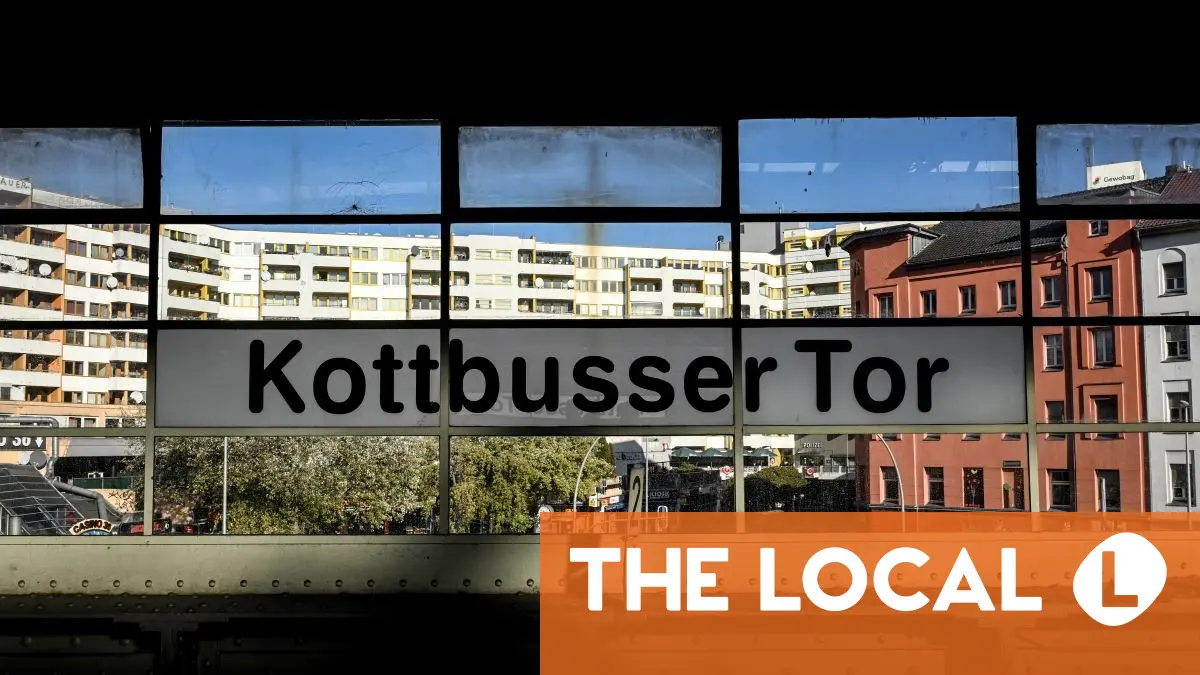 View of the Kottbusser Tor sign overlooking a city skyline from an elevated perspective.